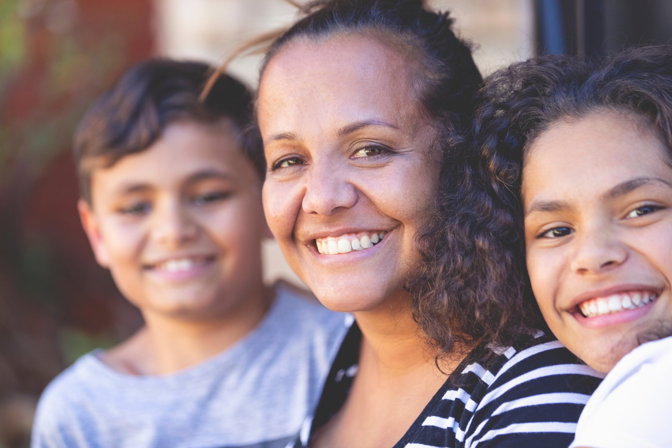 Aboriginal Family portrait with 1 parent and 2 children.