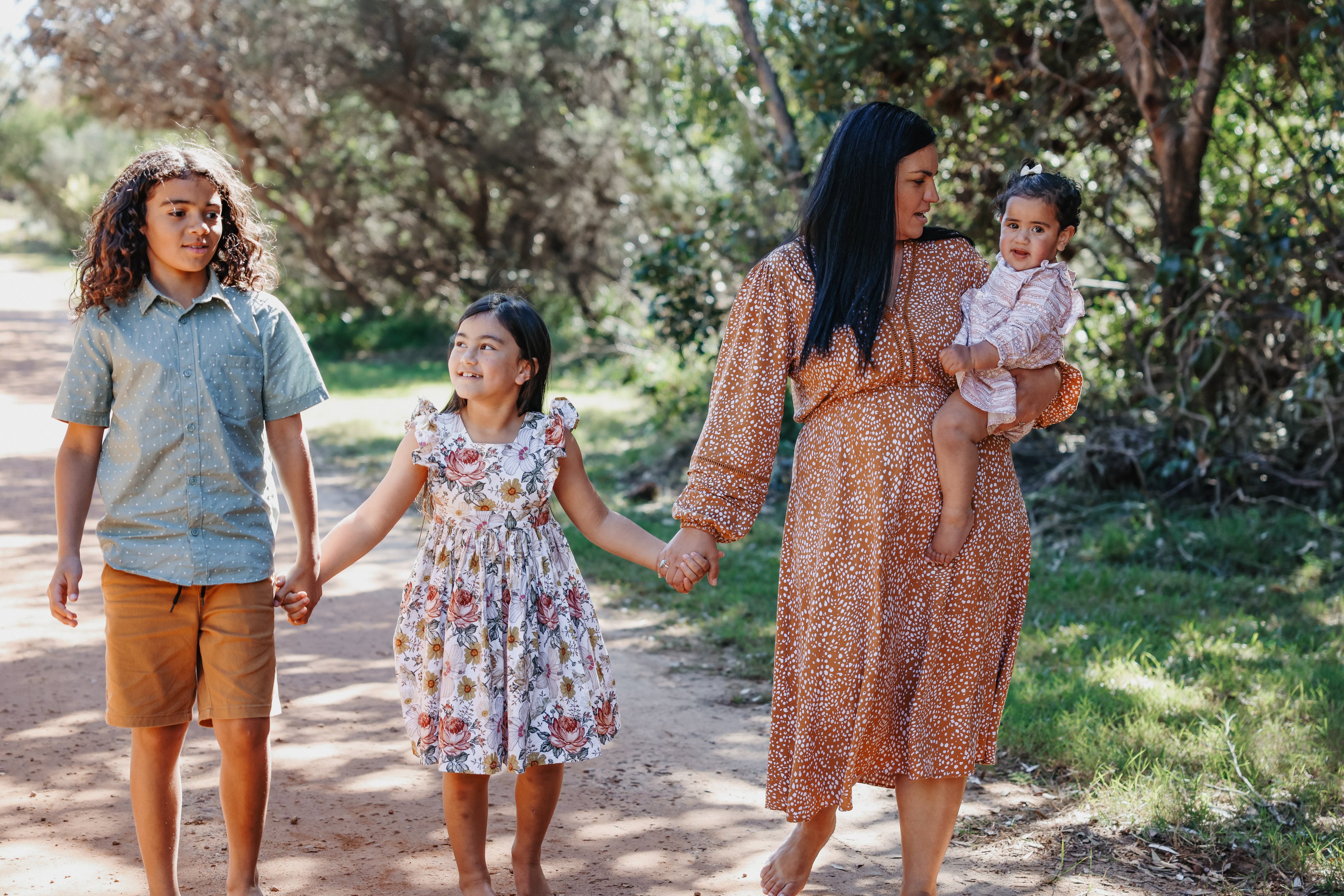 Family Holding Hands While Walking Outdoors